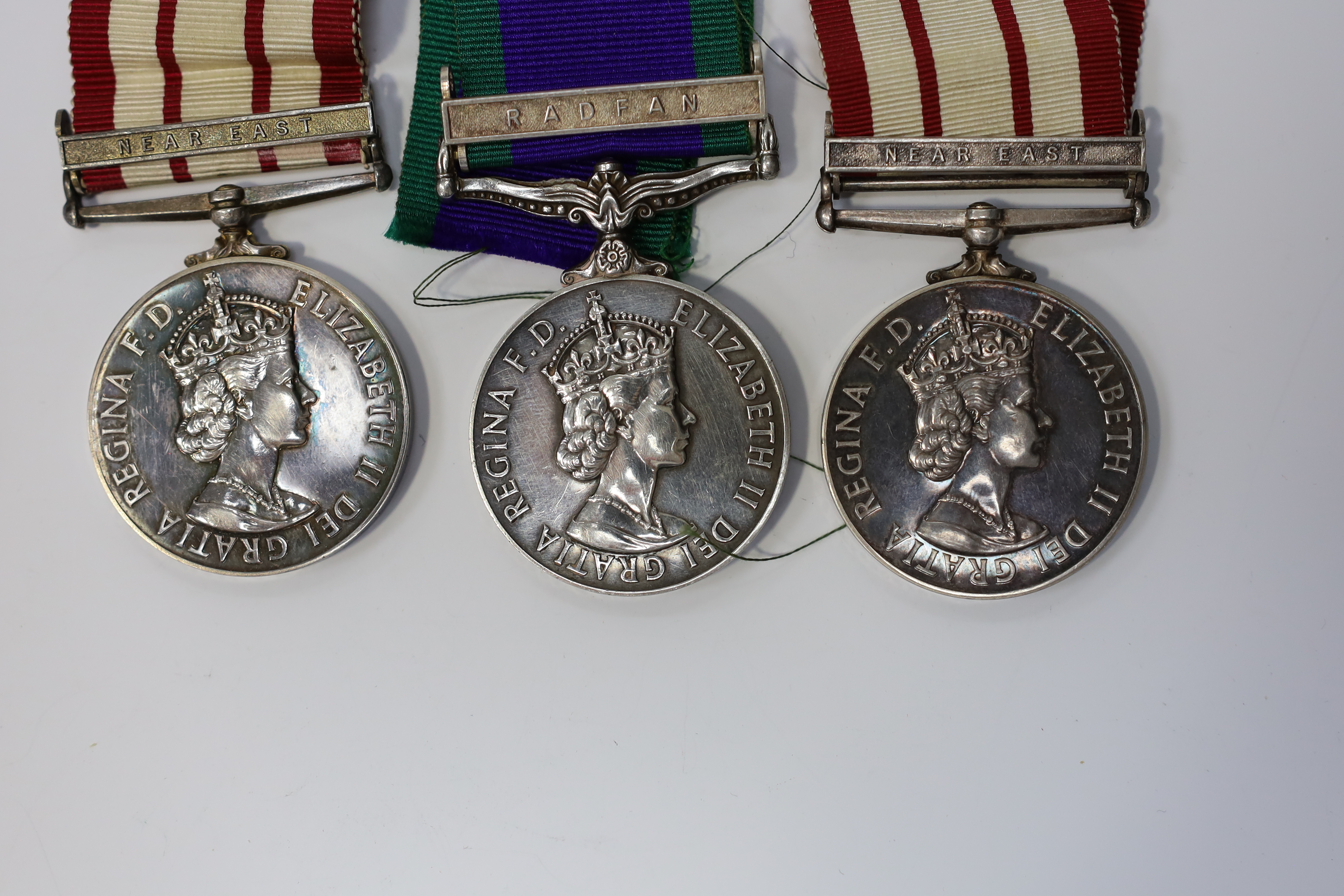 Three ERII Royal Navy medals; a Campaign Service Medal with a bar for Radfan awarded to J. Rush R.E.A.2 R.N., A Naval General Service Medal with a bar for the near East awarded to P/SKX J-C. Shaw M.(E.)1. R.N., plus a se